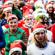 A crowd of people jogging in ugly Christmas sweaters